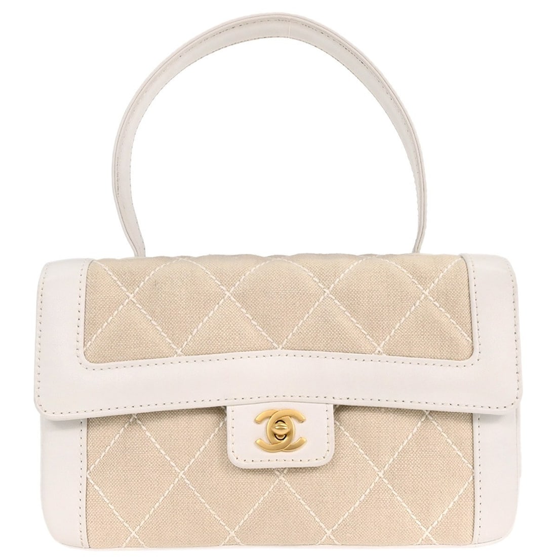 Chanel Canvas and Leather Top Handle Bag in Off-white: Chanel Canvas and Leather Top Handle Bag in Off-white This Chanel top handle bag features an off-white canvas and leather exterior, complemented by a turn lock closure and a medium-sized silhouette. D