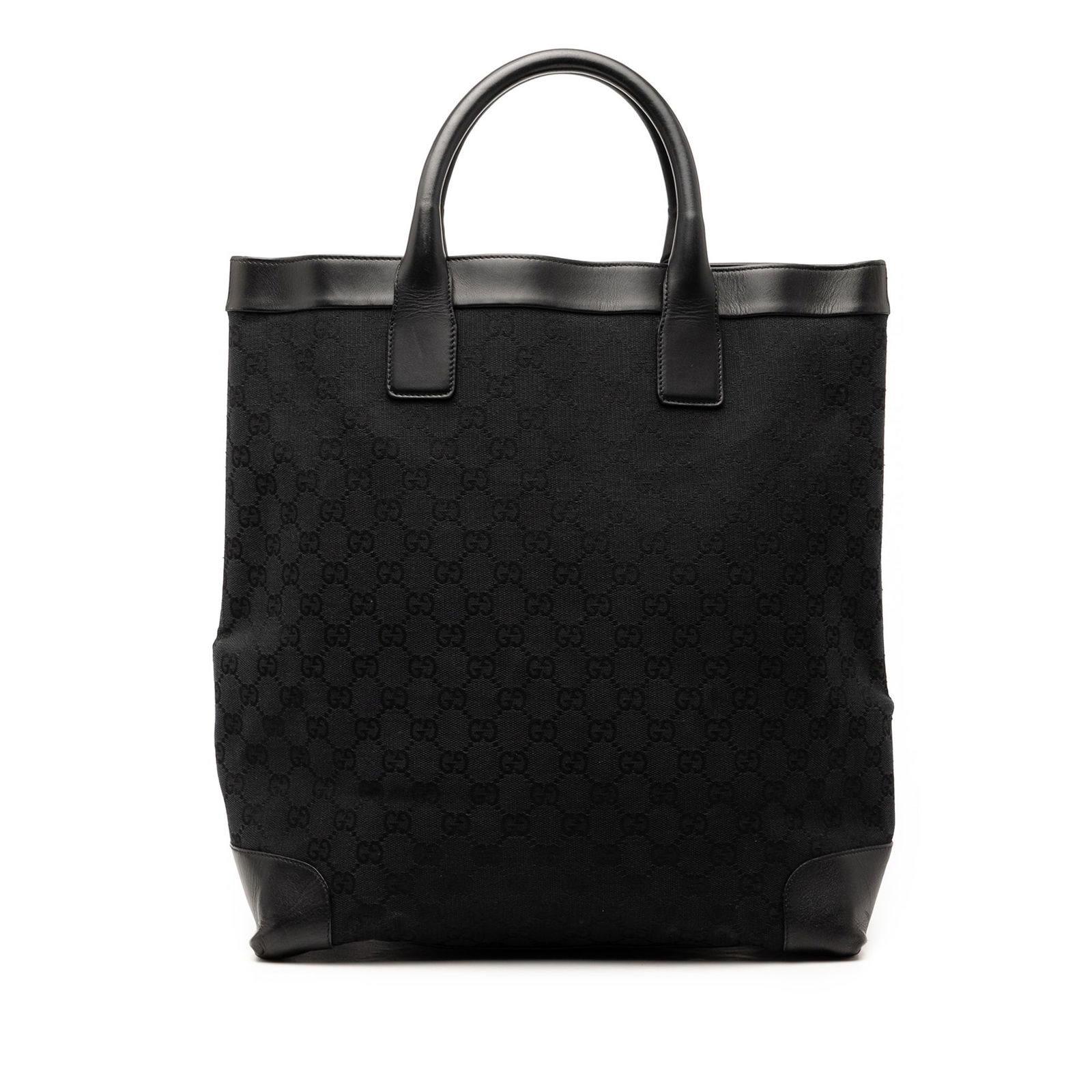 Black GG Canvas Tote Bag with Leather Trim by Gucci: Black GG Canvas Tote Bag with Leather Trim by Gucci This Gucci GG Canvas Tote features a canvas body with leather trim, rolled leather handles, an open top, and an interior zip pocket. The bag is blac