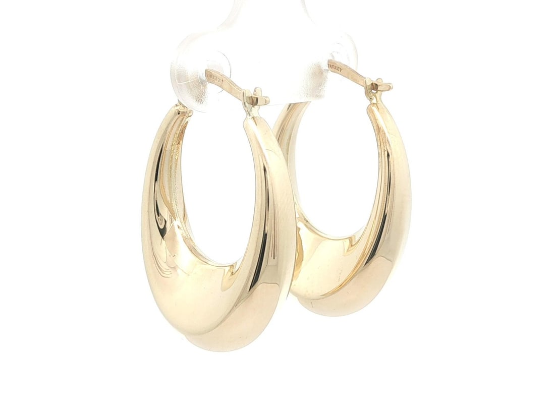 Polished 14k Yellow Gold Puffed Hoop Earrings with Snap Closure: Polished 14k Yellow Gold Puffed Hoop Earrings with Snap Closure These un-used hoop earrings are crafted from solid 14k yellow gold with a polished finish. Featuring a puffed design and classic snap cl