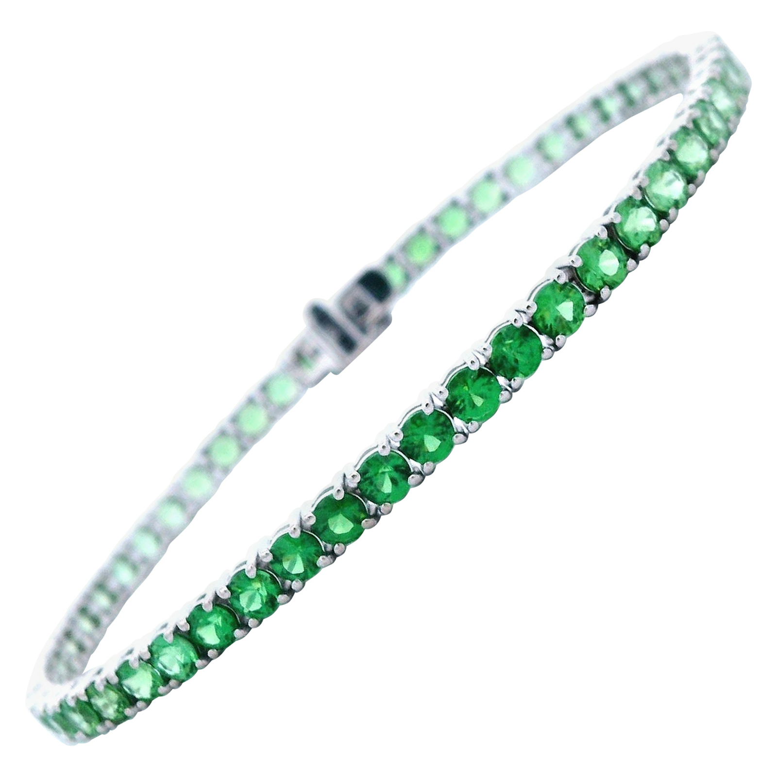 7.14ct Tsavorite Tennis Bracelet in 18k White Gold: 7.14ct Tsavorite Tennis Bracelet in 18k White Gold This exquisite tennis bracelet features 53 round-cut green tsavorite garnets with a total weight of 7.14 carats, elegantly set in 18k white gold. Des
