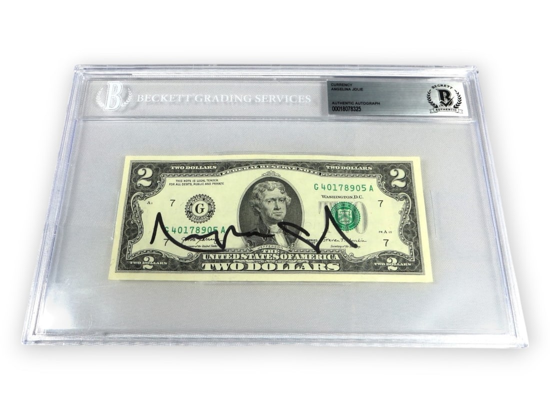 Angelina Jolie Autographed $2 Bill Beckett Authenticated Tomb Raider: Angelina Jolie Autographed $2 Bill Beckett Authenticated Tomb Raider This unique collectible features an authentic autograph from Angelina Jolie on a $2 bill. The bill has been encapsulated and authen