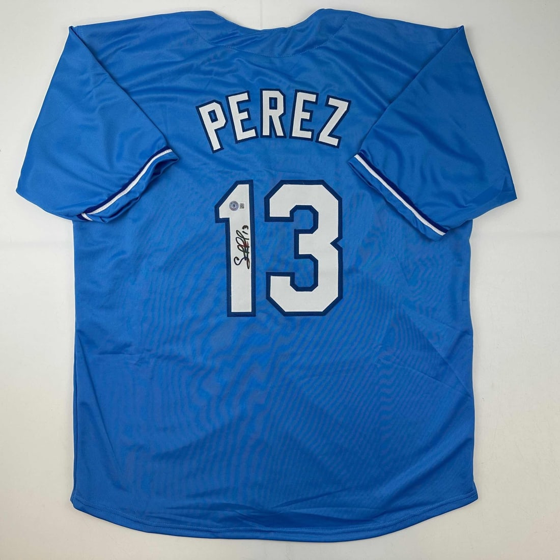Salvador Perez Autographed Kansas City Royals Blue Jersey Beckett COA: Salvador Perez Autographed Kansas City Royals Blue Jersey Beckett COA This is an autographed Salvador Perez Kansas City Royals blue jersey, authenticated by Beckett Grading Services. The jersey is a c