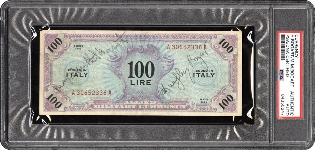 1942 Italian 100 Lire WWII Note Signed by Humphrey and Mayo Methot Bogart PSA DNA: 1942 Italian 100 Lire WWII Note Signed by Humphrey and Mayo Methot Bogart PSA DNA This is an original Allied military currency 100 Lire note from World War II, dated 1942. The note measures 6 inches b