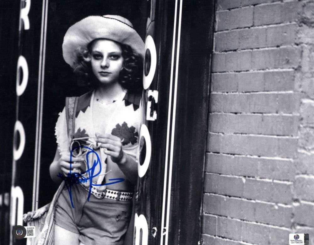 Jodie Foster Autographed 11x14 Taxi Driver Photo Beckett Authenticated: Jodie Foster Autographed 11x14 Taxi Driver Photo Beckett Authenticated This is an original 11x14 photograph of Jodie Foster, renowned for her role in the classic film "Taxi Driver." The photo features