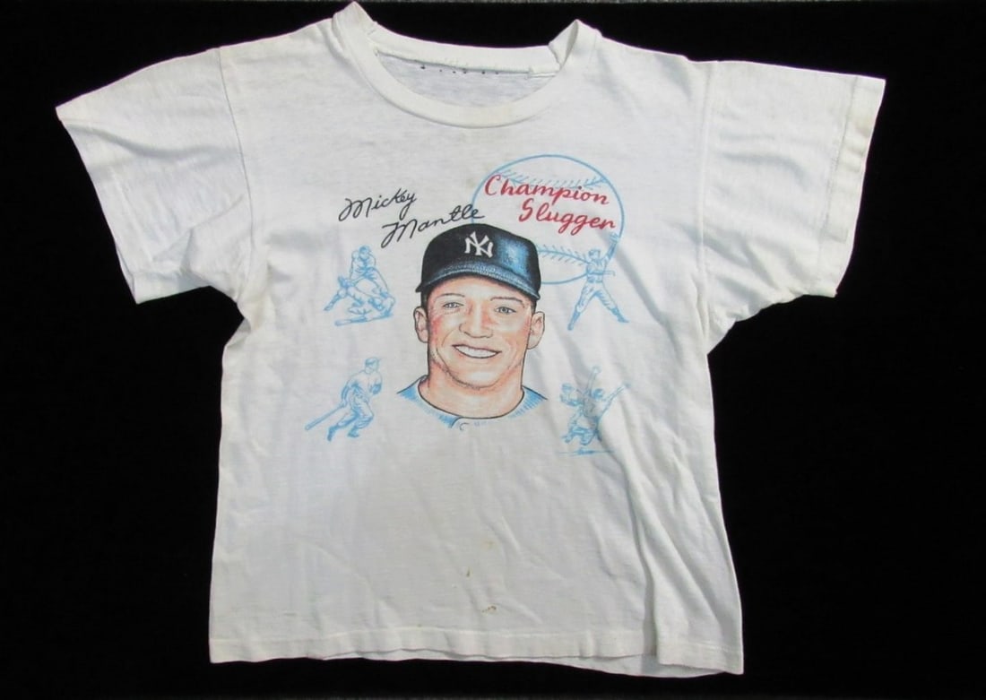 Vintage Mickey Mantle Champion Slugger Child T-shirt 1950s Yankees: Vintage Mickey Mantle Champion Slugger Child T-shirt 1950s Yankees Presenting a vintage Mickey Mantle "Champion Slugger" child's t-shirt from the 1950s, representing the iconic era of baseball. This s