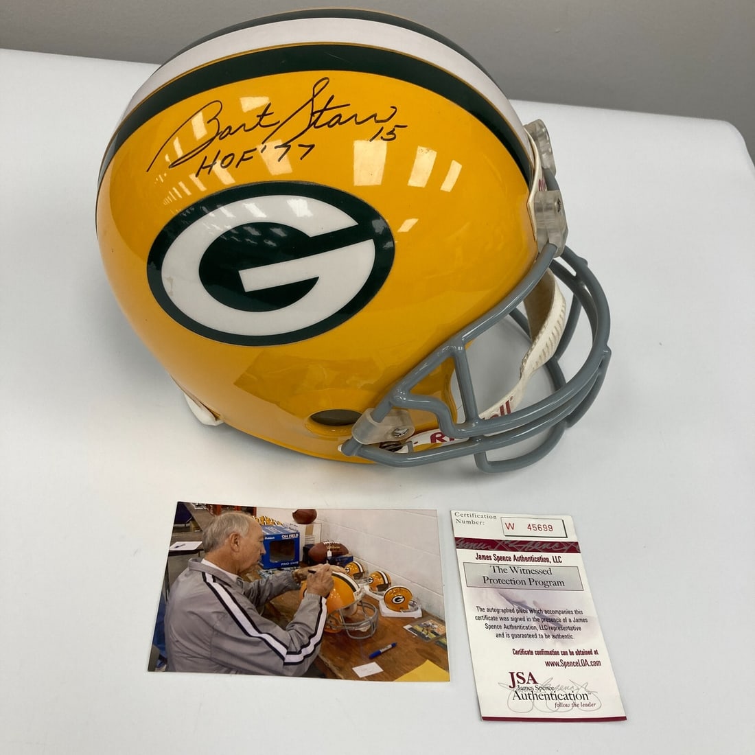 Bart Starr Signed Full Size Packers Helmet Hall Of Fame 1977 JSA COA: Bart Starr Signed Full Size Packers Helmet Hall Of Fame 1977 JSA COA This is a full-size Green Bay Packers helmet signed by Bart Starr, featuring the inscription "Hall Of Fame 1977." The helmet is an