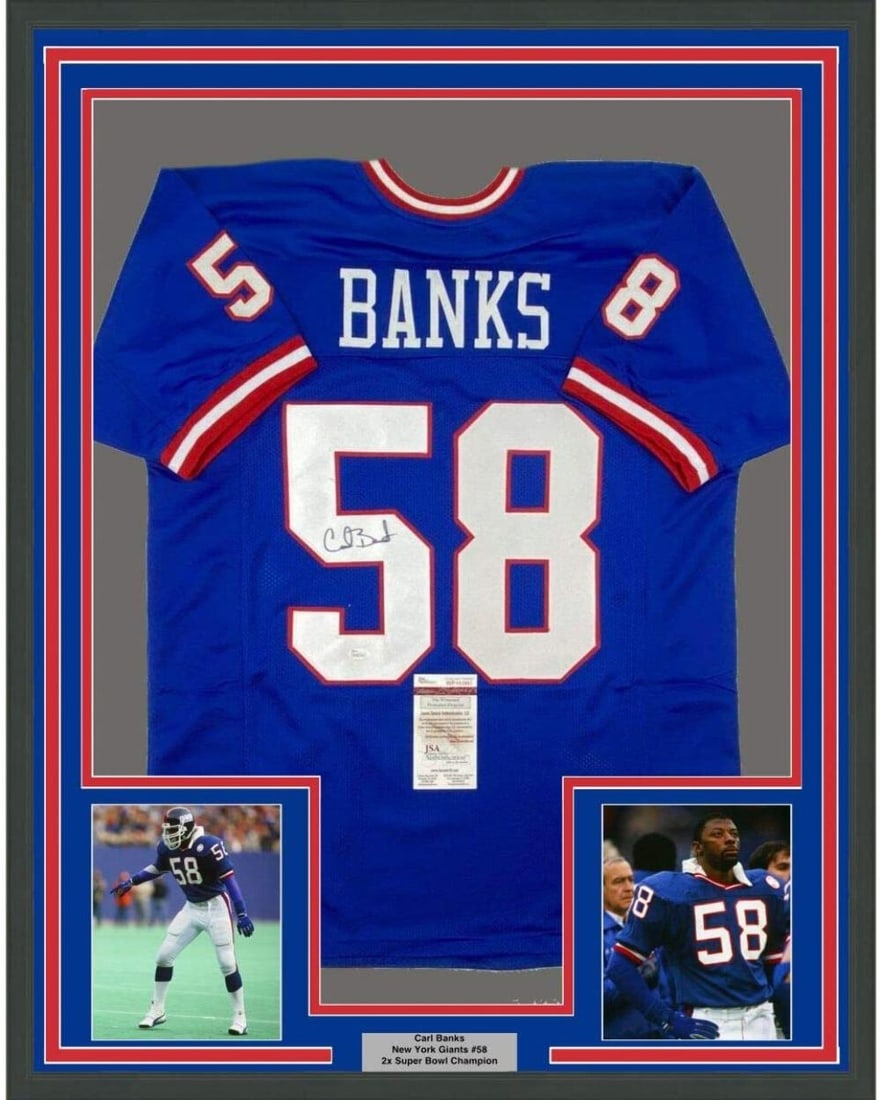 Carl Banks Signed New York Giants Jersey 33x42 Framed with JSA Authentication: Carl Banks Signed New York Giants Jersey 33x42 Framed with JSA Authentication This framed New York Giants jersey features an authentic autograph from Carl Banks. The jersey measures 33x42 inches and c