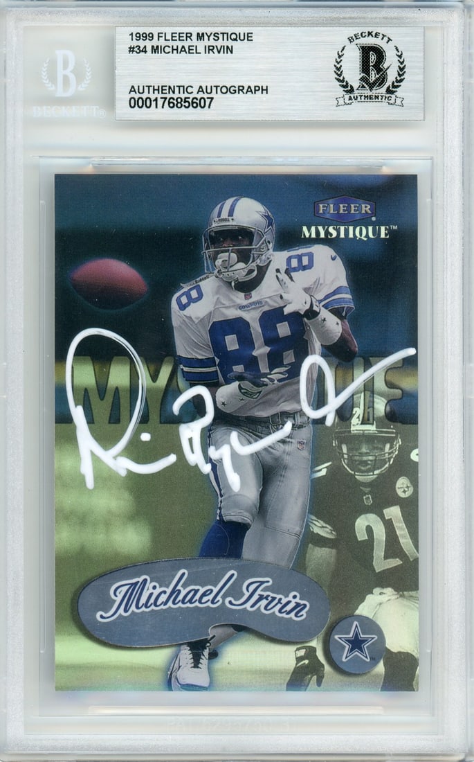 Michael Irvin Signed 1999 Fleer Mystique Football Card Graded BGS #34: Michael Irvin Signed 1999 Fleer Mystique Football Card Graded BGS #34 This is an original 1999 Fleer Mystique #34 sports trading card featuring Michael Irvin of the Dallas Cowboys. The card is hand-si