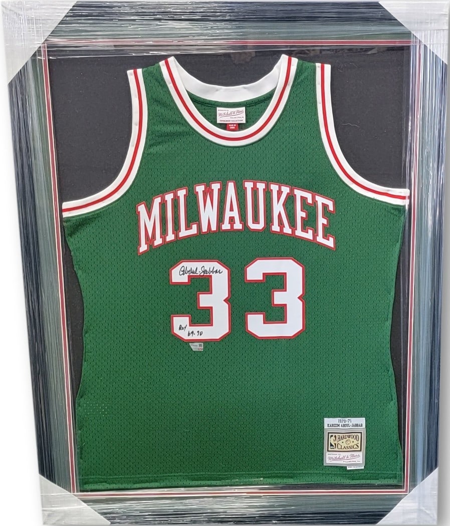 Kareem Abdul Jabbar Signed Framed Jersey Bucks with ROY 69-70 Inscription: Kareem Abdul Jabbar Signed Framed Jersey Bucks with ROY 69-70 Inscription Celebrate the legacy of basketball legend Kareem Abdul Jabbar with this original signed Mitchell & Ness jersey. This authentic