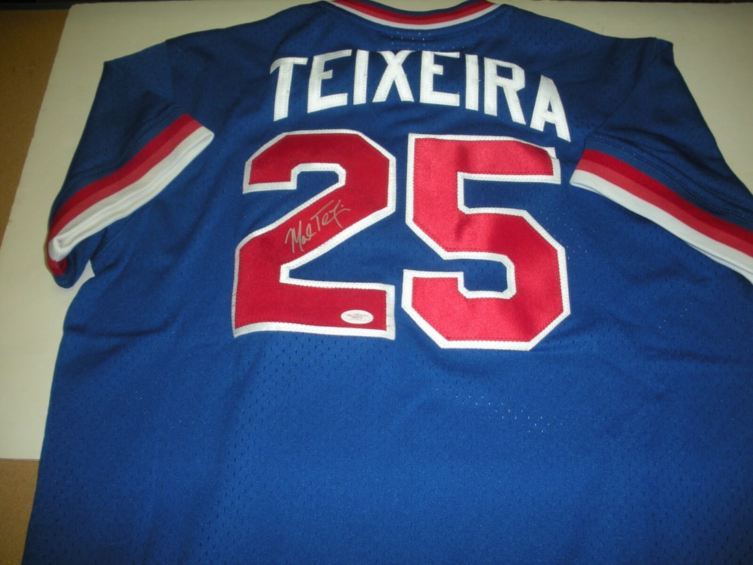 Mark Teixeira Signed Mitchell & Ness Braves Jersey JSA COA: Mark Teixeira Signed Mitchell & Ness Braves Jersey JSA COA This official licensed Mitchell & Ness jersey features the signature of Mark Teixeira, a former professional baseball player known for his ti