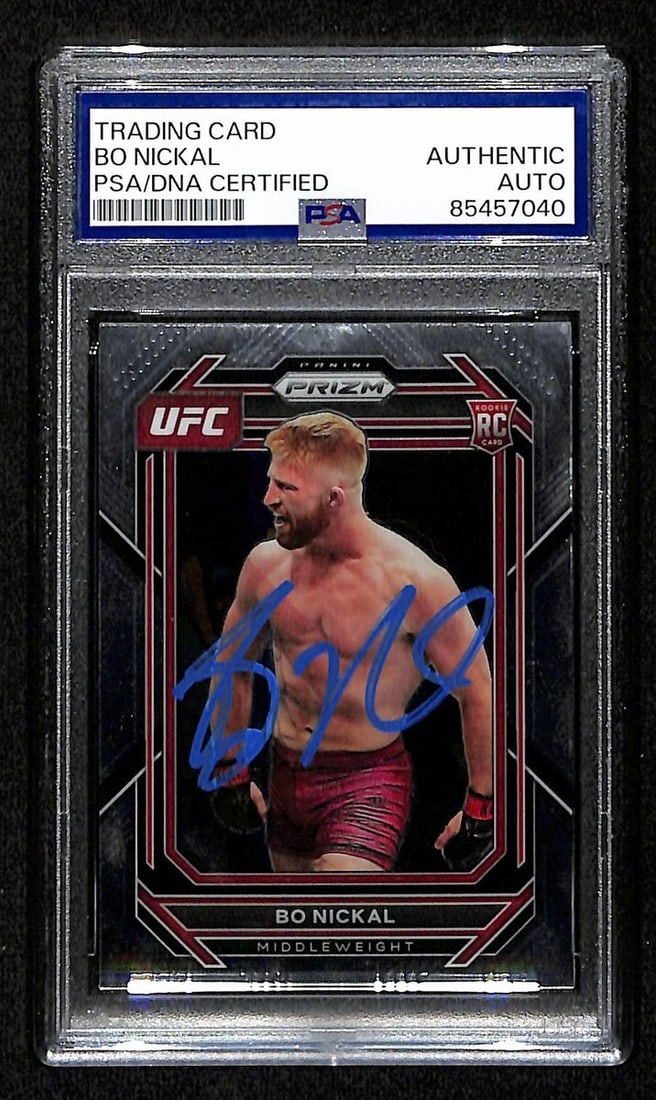 Bo Nickal Signed 2023 UFC Panini Prizm Rookie Card PSA/DNA Authenticated: Bo Nickal Signed 2023 UFC Panini Prizm Rookie Card PSA/DNA Authenticated This offering features a Bo Nickal Signed 2023 UFC Panini Prizm Rookie RC Card #103. The card is authenticated by PSA/DNA and c