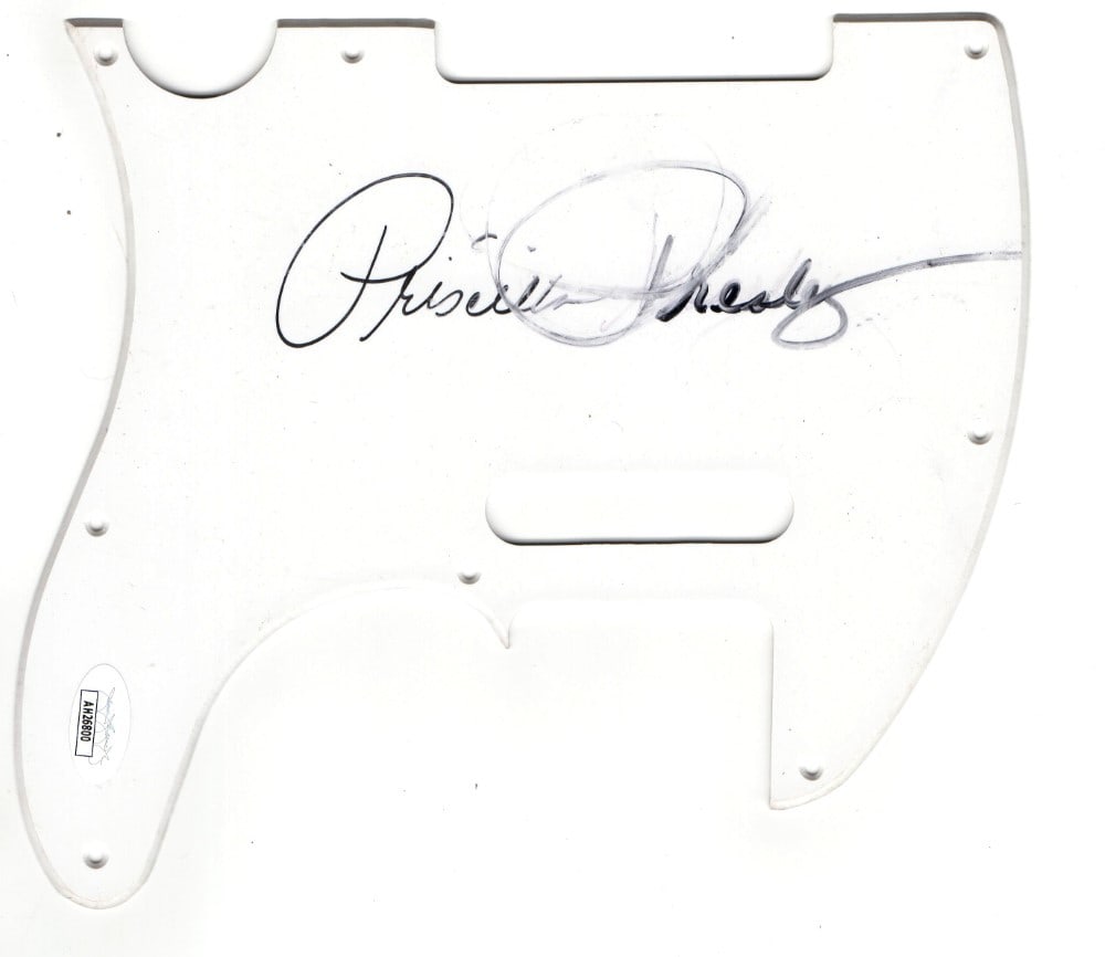 Priscilla Presley Autographed Guitar Pickguard JSA Certified: Priscilla Presley Autographed Guitar Pickguard JSA Certified This authentic electric guitar pickguard is signed by Priscilla Presley, a notable figure closely associated with Elvis Presley. The autogr