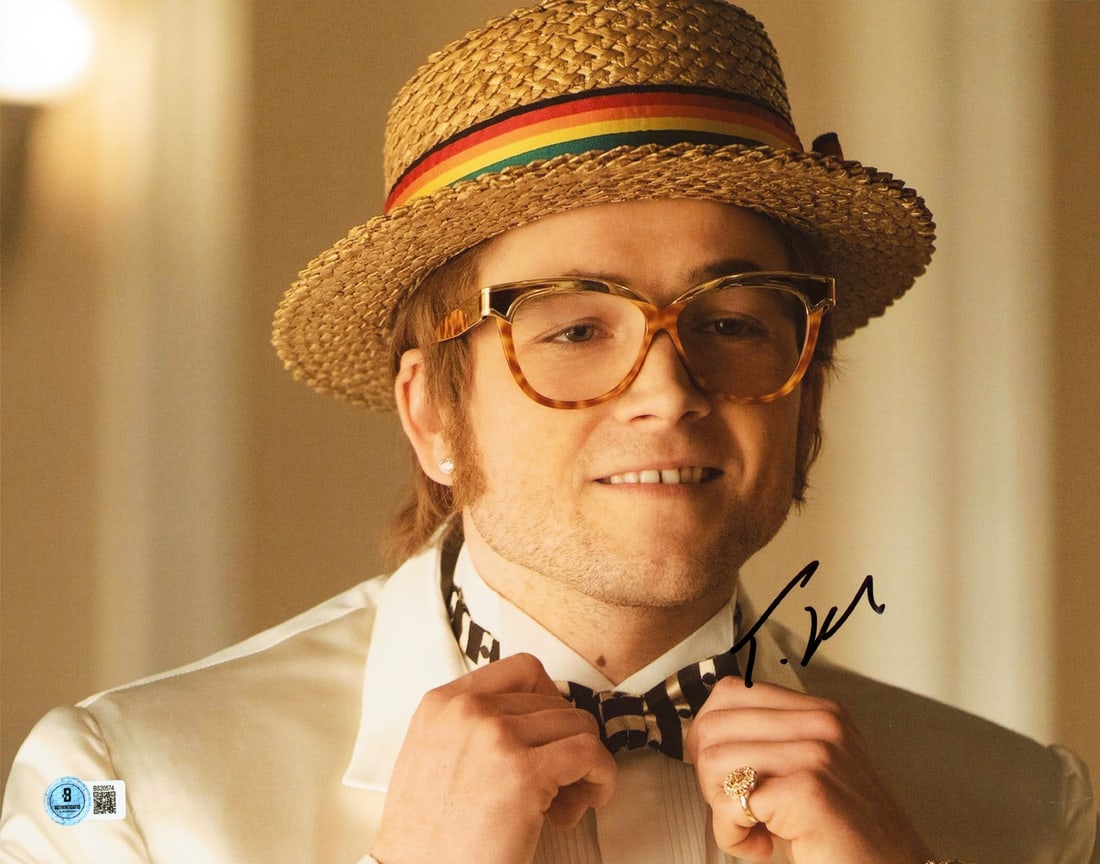 Taron Egerton Rocketman Signed 11x14 Photo with Beckett Authentication: Taron Egerton Rocketman Signed 11x14 Photo with Beckett Authentication Capture a moment from the acclaimed film 'Rocketman' with this authentic signed 11x14 horizontal photograph of Taron Egerton. Thi
