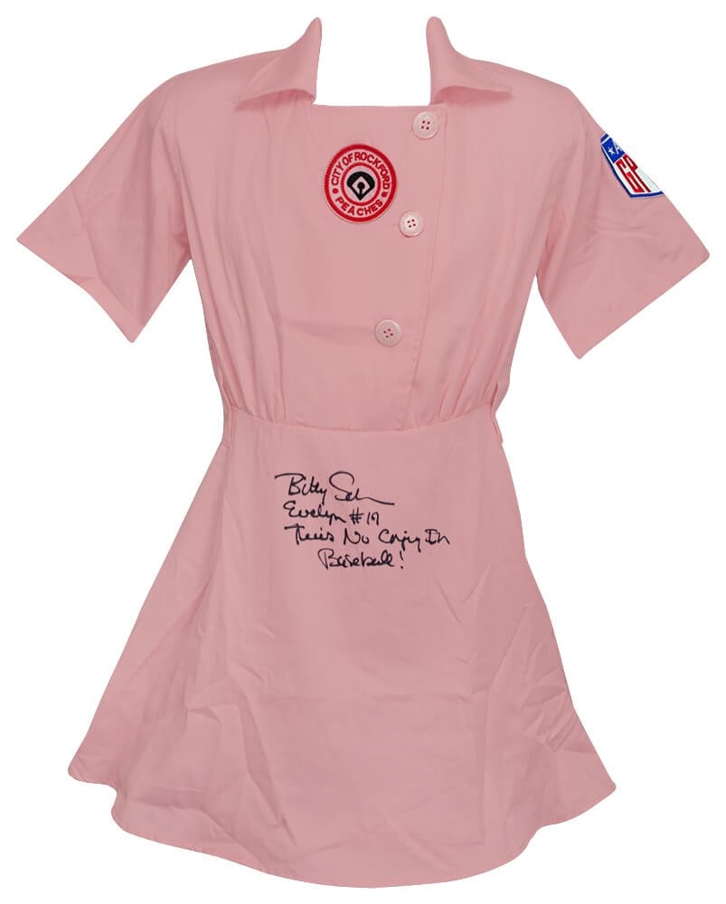 Bitty Schram Signed Rockford Peaches Jersey with Inscriptions COA: Bitty Schram Signed Rockford Peaches Jersey with Inscriptions COA This authentic Rockford Peaches pink costume baseball jersey is signed by Bitty Schram, featuring inscriptions of 'Evelyn' and the ico