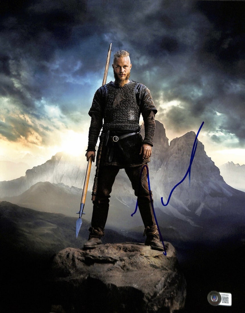 Travis Fimmel Signed 11x14 Vikings Photo Beckett Certified: Travis Fimmel Signed 11x14 Vikings Photo Beckett Certified This striking 11x14 photograph features Travis Fimmel, renowned for his role as "Ragnar" in the acclaimed TV series Vikings. The image is aut