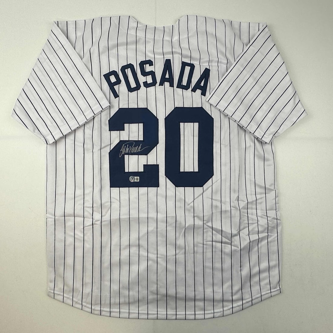 Jorge Posada Autographed New York Yankees Pinstripe Jersey Beckett COA: Jorge Posada Autographed New York Yankees Pinstripe Jersey Beckett COA This autographed Jorge Posada New York Pinstripe Jersey is a must-have for any New York Yankees fan. The jersey features the name