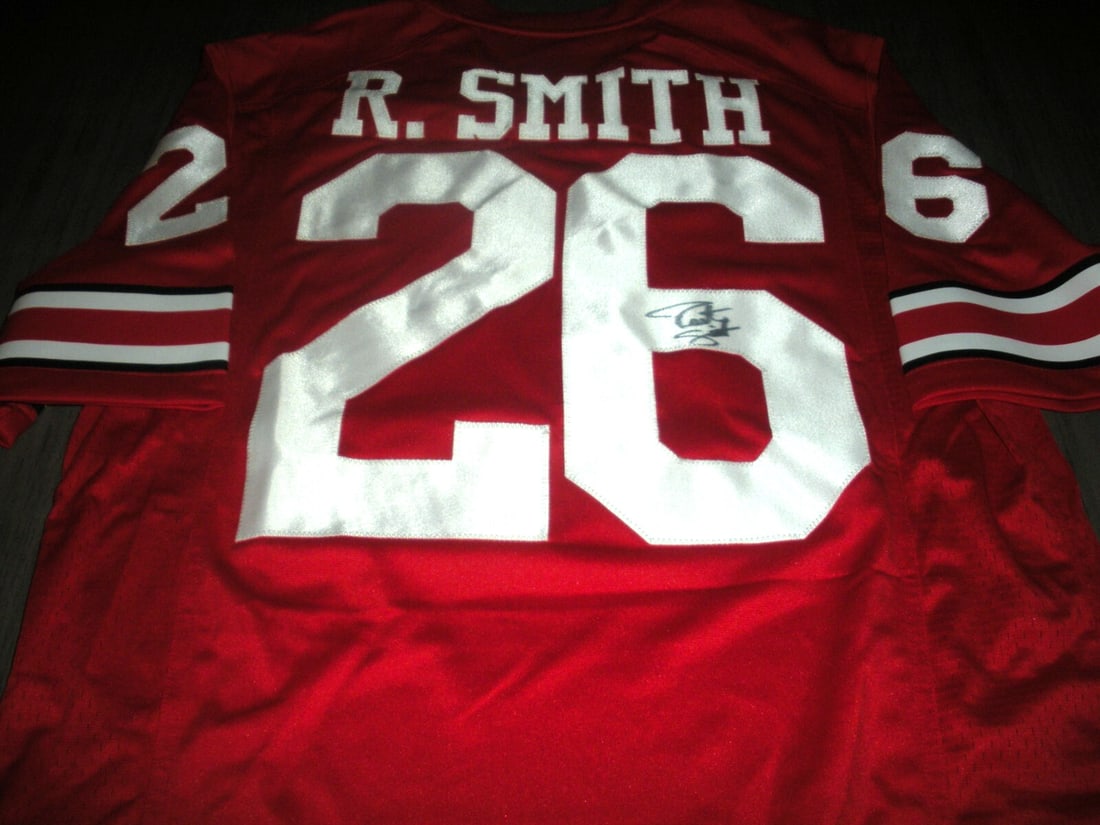 Robert Smith Signed Ohio State Buckeyes Nike Jersey with COA: Robert Smith Signed Ohio State Buckeyes Nike Jersey with COA This official licensed Nike jersey features the signature of Robert Smith, a notable player for the Ohio State Buckeyes. It is a