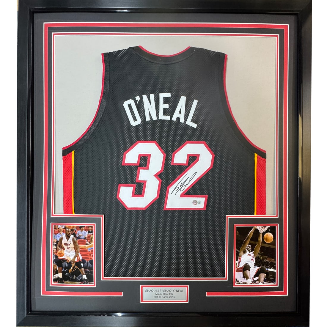 Framed Autographed Shaquille O'Neal Miami Heat Jersey with JSA COA: Framed Autographed Shaquille O'Neal Miami Heat Jersey with JSA COA This professionally framed and matted jersey features the iconic autograph of Shaquille O'Neal, a celebrated NBA player. Measuring 33