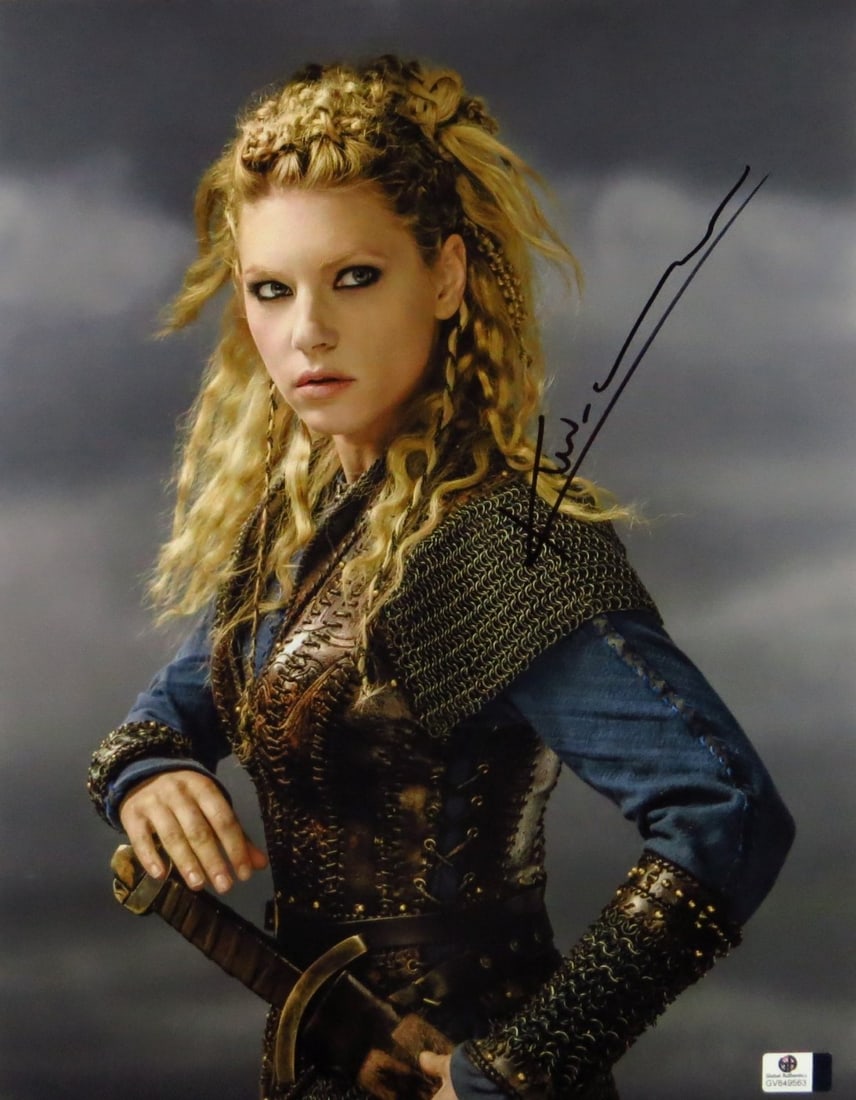 Katheryne Winnick Autographed 11X14 Photo Vikings GAI Certified: Katheryne Winnick Autographed 11X14 Photo Vikings GAI Certified This stunning 11x14 photograph features Katheryne Winnick, known for her role in the hit series 'Vikings,' striking a fierce pose with a