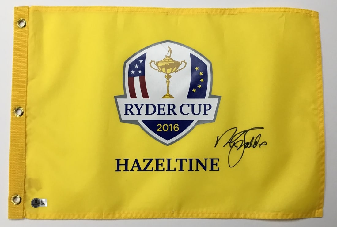 Nick Faldo Signed 2016 Ryder Cup Hazeltine Pin Flag Beckett Authenticated: Nick Faldo Signed 2016 Ryder Cup Hazeltine Pin Flag Beckett Authenticated Celebrate golf history with this original 2016 Ryder Cup Hazeltine pin flag, expertly signed by PGA legend Nick Faldo. The sig