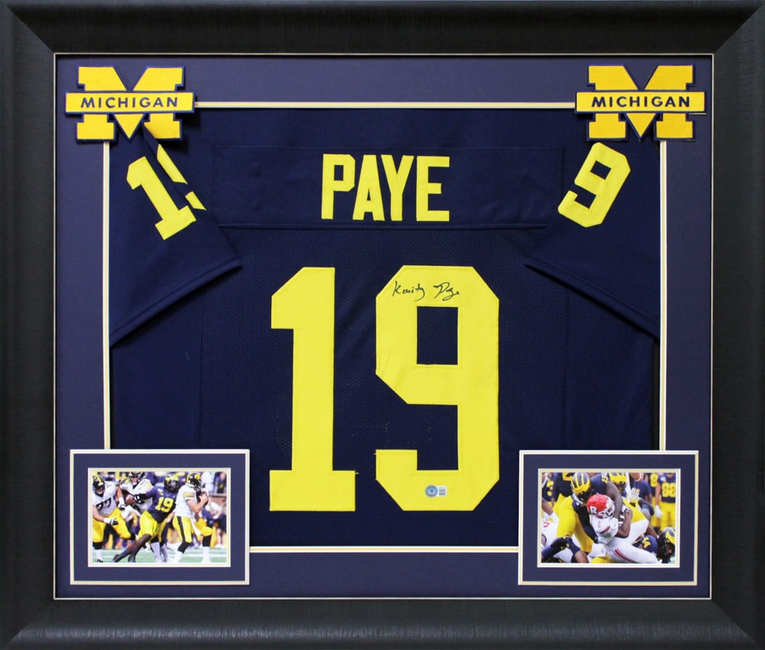 Kwity Paye Signed Michigan Wolverines Framed Jersey BAS Witnessed: Kwity Paye Signed Michigan Wolverines Framed Jersey BAS Witnessed This autographed navy blue pro style framed jersey features the signature of Kwity Paye, a standout player from the Michigan Wolverine