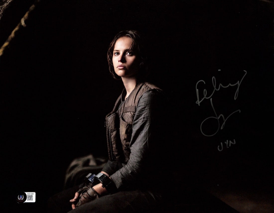 Signed 11x14 Photo of Felicity Jones as Jyn Erso with Beckett Authentication: Signed 11x14 Photo of Felicity Jones as Jyn Erso with Beckett Authentication This is an original 11x14 color photograph signed by Felicity Jones, who portrayed Jyn Erso in Star Wars Rogue One. The aut