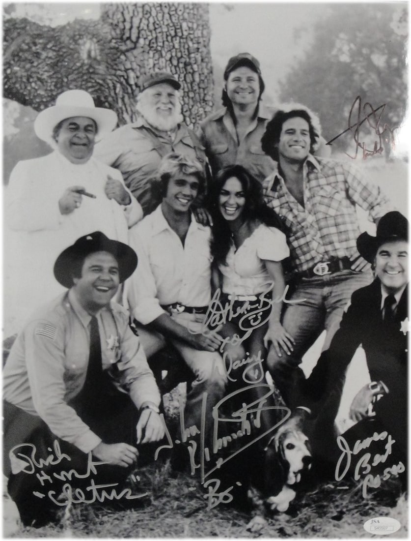 Dukes of Hazzard Signed 11x14 Photo by Cast JSA Authenticated: Dukes of Hazzard Signed 11x14 Photo by Cast JSA Authenticated This exceptional 11x14 photograph from the beloved show 'The Dukes of Hazzard' features the signatures of five cast members: Catherine Bac