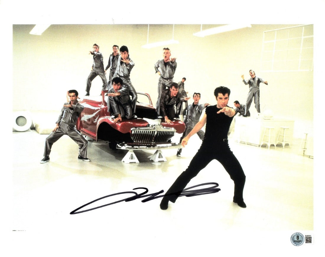 John Travolta Signed 11.5x14.5 Photograph Grease Beckett Authenticated: John Travolta Signed 11.5x14.5 Photograph Grease Beckett Authenticated This is an original 11.5 x 14.5 inch photograph autographed by John Travolta, known for his role in "Grease." The signature has b