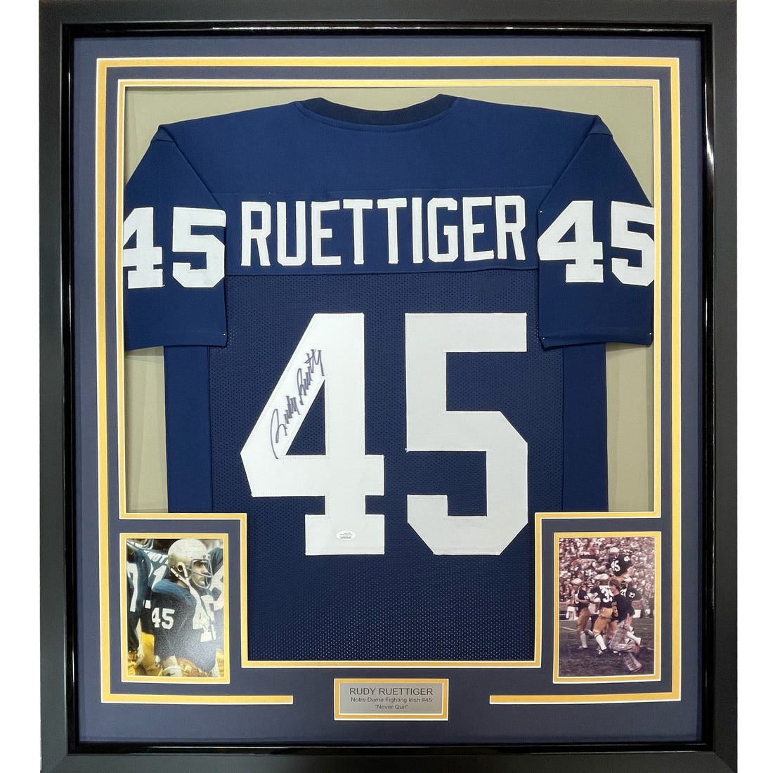 Framed Autographed Rudy Ruettiger Notre Dame Jersey with JSA COA 33x42: Framed Autographed Rudy Ruettiger Notre Dame Jersey with JSA COA 33x42 Celebrate the legacy of Rudy Ruettiger with this professionally framed and autographed Notre Dame Fighting Irish blue jersey. Mea