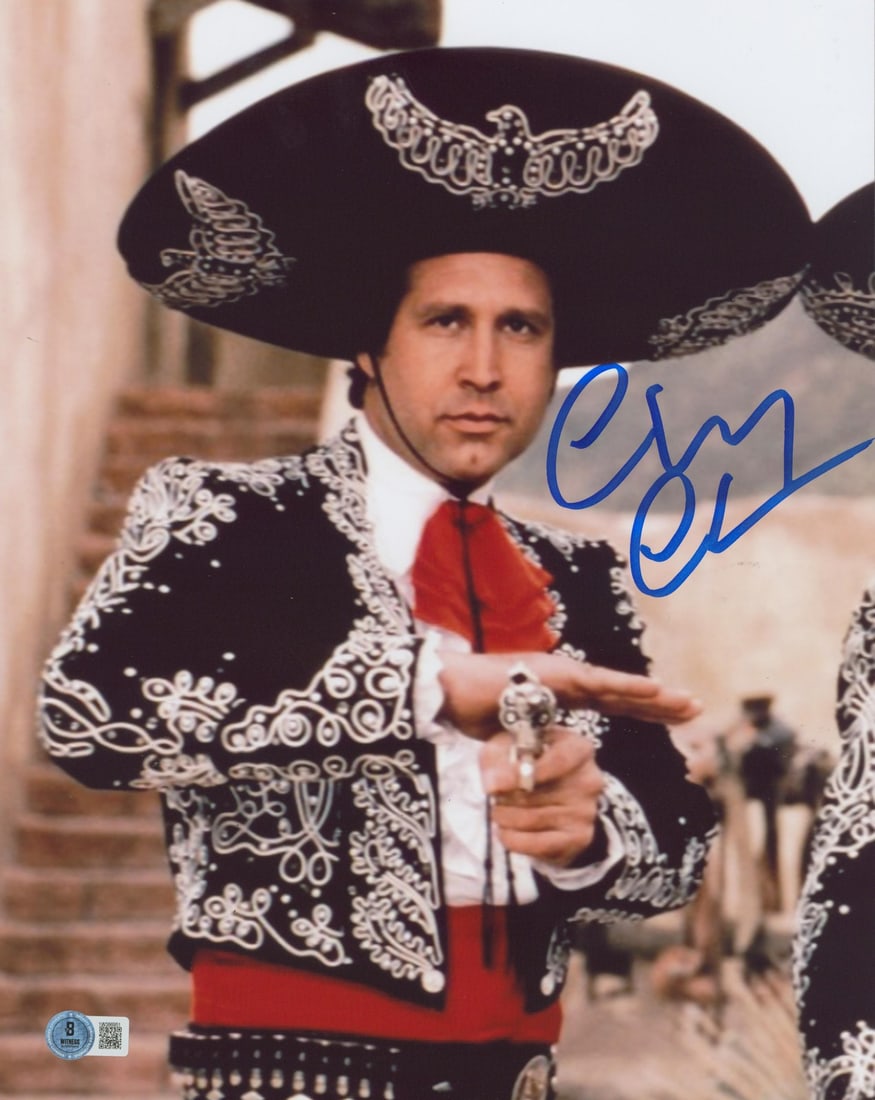 Chevy Chase Signed 11x14 Three Amigos Close-Up Photo BAS Witnessed: Chevy Chase Signed 11x14 Three Amigos Close-Up Photo BAS Witnessed This stunning 11x14 photograph captures Chevy Chase in a close-up shot with his gun drawn from the iconic film "Three Amigos!" The ph