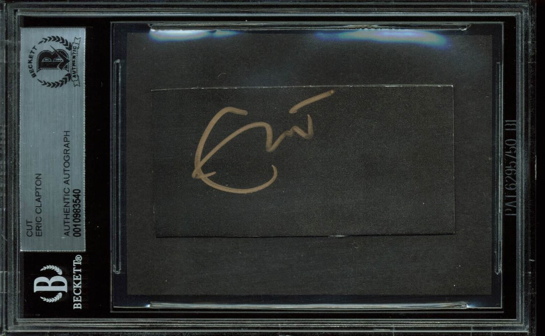 Eric Clapton Signed Cut Signature 1.4x2.85 BAS Authenticated: Eric Clapton Signed Cut Signature 1.4x2.85 BAS Authenticated This authentic cut signature measures 1.4x2.85 inches and features the personal autograph of music legend Eric Clapton. It has been profess