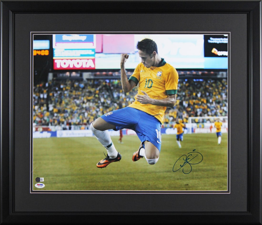 Neymar Jr. Autographed 16x20 Framed Photo Brazil PSA/DNA: Neymar Jr. Autographed 16x20 Framed Photo Brazil PSA/DNA This impressive 16x20 framed photo features the authentic signature of Neymar Jr., a star player of the Brazil National Football Team. The phot