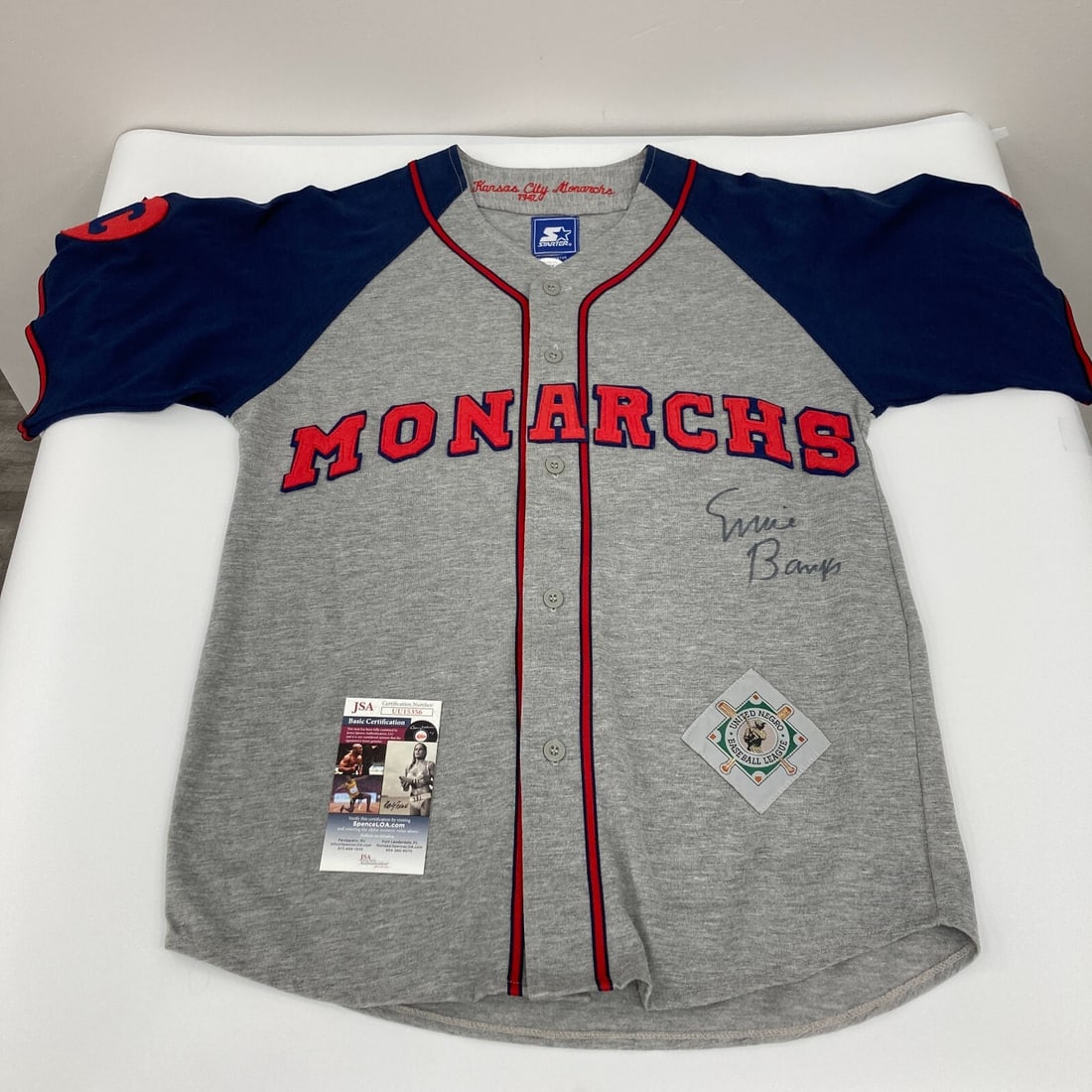 Rare Ernie Banks Autographed Kansas City Monarchs Jersey JSA Certified: Rare Ernie Banks Autographed Kansas City Monarchs Jersey JSA Certified This rare jersey, signed by legendary baseball player Ernie Banks, showcases his affiliation with the Kansas City Monarchs of the
