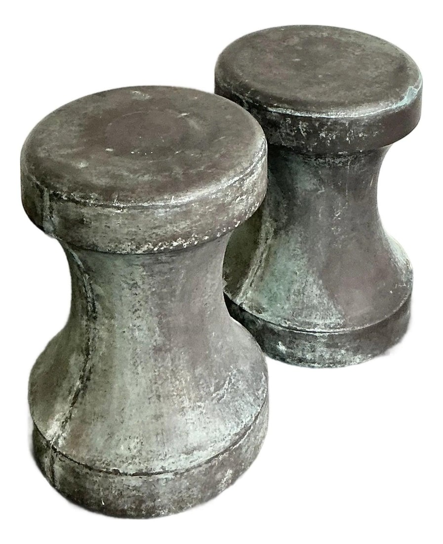 Pair of Freda Verdigris Concrete Over Fiberglass Drum Stools: Pair of Freda Verdigris Concrete Over Fiberglass Drum Stools This pair of "Freda" stools by Made Goods showcases a distinctive hourglass silhouette and is expertly crafted with a concrete overlay on a