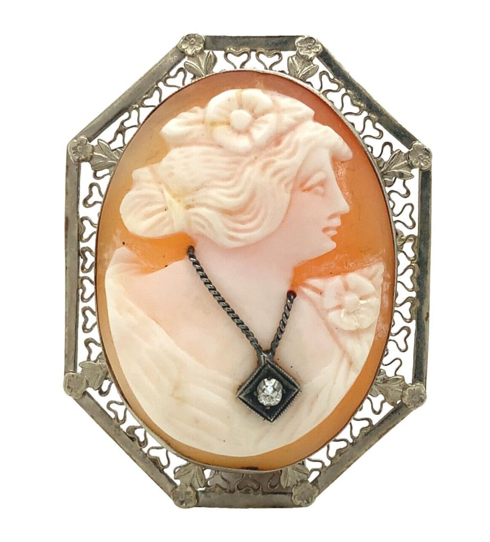 14k White Gold Art Deco Shell Cameo Pin Pendant with Diamond: 14k White Gold Art Deco Shell Cameo Pin Pendant with Diamond This exquisite 14k white gold shell cameo pin pendant features a stunning Art Deco filigree frame adorned with a diamond. The centerpiece s