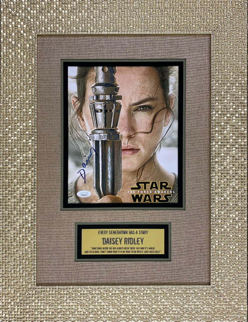 Daisy Ridley Rey Signed Star Wars Photo Custom Framed JSA COA 17x24: Daisy Ridley Rey Signed Star Wars Photo Custom Framed JSA COA 17x24 This custom framed display features a signed photograph of Daisy Ridley as Rey from the Star Wars franchise, specifically from the m
