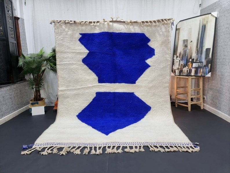 Artistic Moroccan Berber Wool Rug Soft White Blue Handmade: Artistic Moroccan Berber Wool Rug Soft White Blue Handmade Enhance your living space with this exquisite Soft White & Blue Handmade Moroccan Berber Wool Rug. Crafted by skilled local Berber women weav