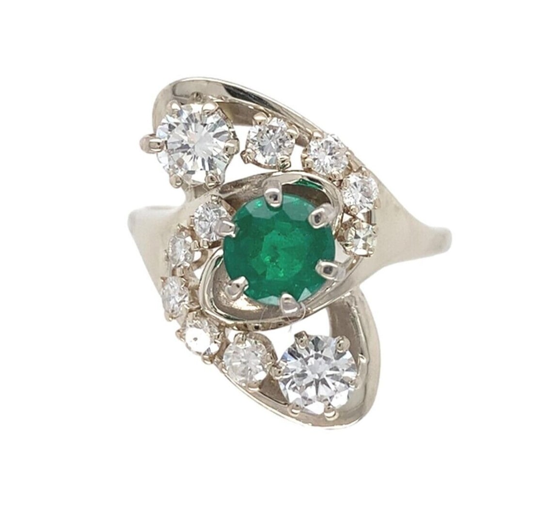 14k White Gold Emerald Diamond Cocktail Ring .65ct GIA Certified: 14k White Gold Emerald Diamond Cocktail Ring .65ct GIA Certified This exquisite 14k white gold cocktail ring showcases a stunning .65ct genuine natural emerald at its center, surrounded by eleven spar