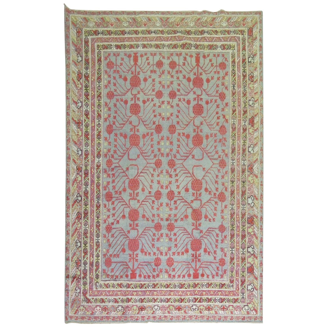 Zabihi Collection 1920 Khotan Hand-Woven Wool Rug with Pomegranates: Zabihi Collection 1920 Khotan Hand-Woven Wool Rug with Pomegranates This exquisite early 20th century Khotan rug showcases a beautiful blend of traditional craftsmanship and vibrant design. Hand-woven