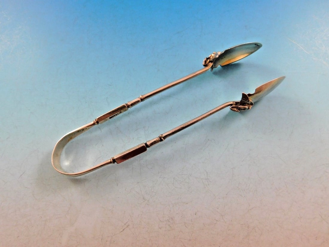 Gorham Isis Sterling Silver Sugar Tongs with Snake and Wings 4 3/4": Gorham Isis Sterling Silver Sugar Tongs with Snake and Wings 4 3/4" This exquisite sugar tong from the renowned Gorham brand features the intricate Isis pattern, dating back to the late 19th century