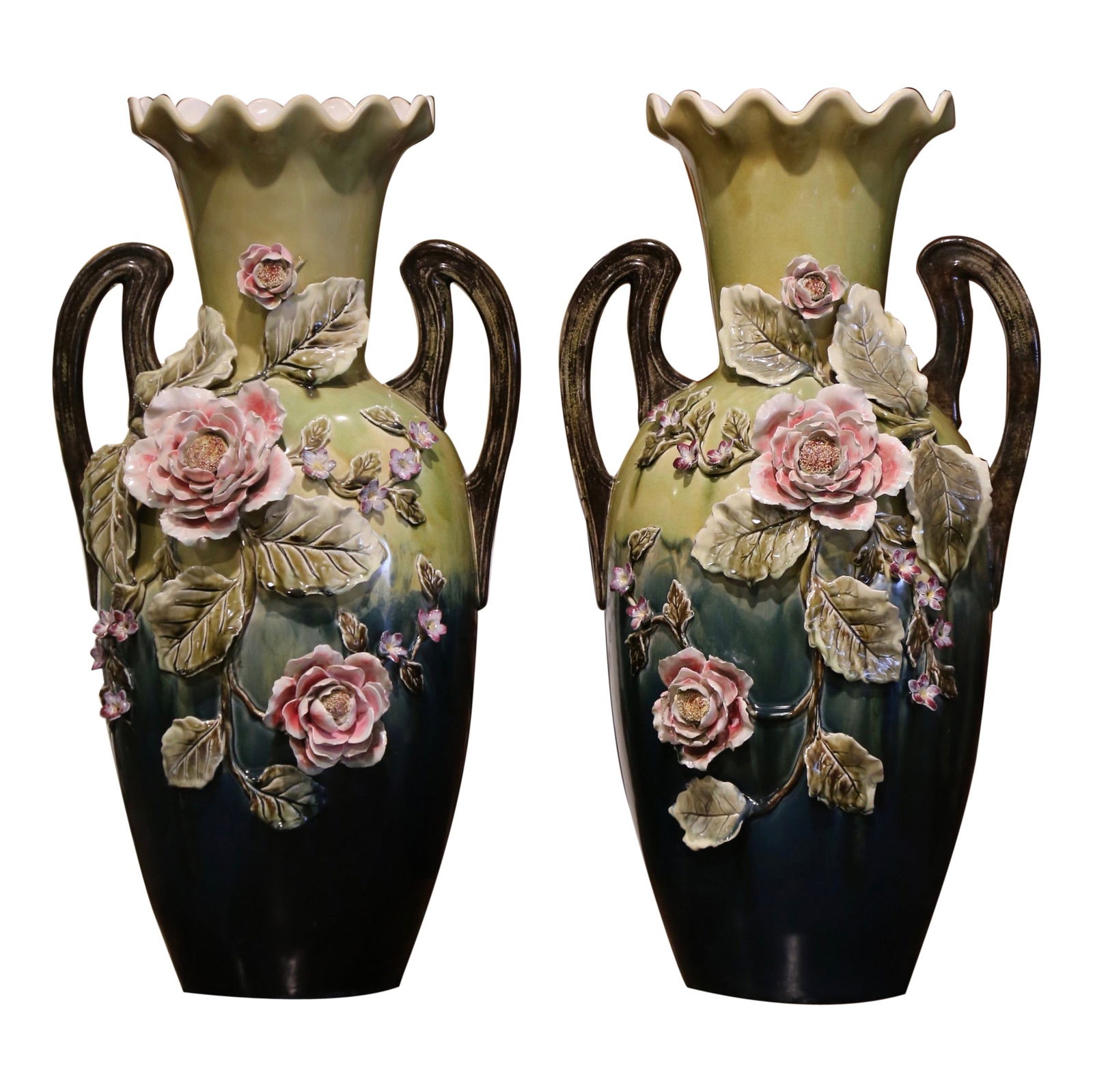 Set of 2 French Majolica Floral Faience Vases with Handles circa 1950: Set of 2 French Majolica Floral Faience Vases with Handles circa 1950 This set of two mid-century French barbotine vases showcases vibrant hand-painted floral motifs in high relief, featuring blooming