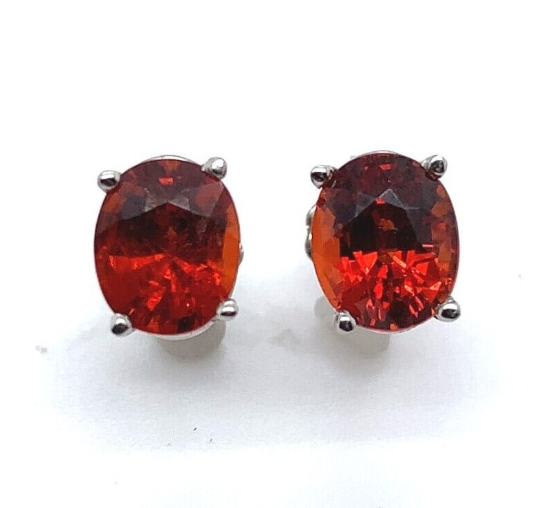 Platinum Oval Spessartine Garnet Stud Earrings 2.75cttw GIA Certified: Platinum Oval Spessartine Garnet Stud Earrings 2.75cttw GIA Certified Enhance your jewelry collection with these exquisite Platinum Genuine Natural Spessartine Garnet Stud Earrings. Featuring stunning
