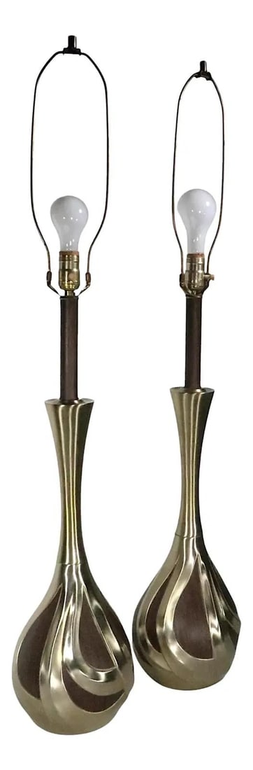 Chic Pair of 1960s Mid Century Genie Bottle Lamps: Chic Pair of 1960s Mid Century Genie Bottle Lamps This chic pair of mid-century table lamps, crafted circa 1960s, showcases a unique genie bottle form with metal bodies adorned with faux wood inlay. T