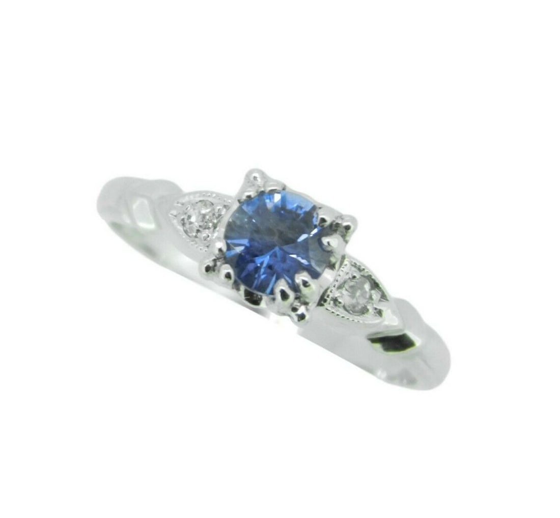 Vintage Platinum 0.49ct Blue Sapphire Diamond Ring GIA Certified: Vintage Platinum 0.49ct Blue Sapphire Diamond Ring GIA Certified This exquisite platinum ring features a stunning round natural sapphire weighing 0.49 carats, radiant in its medium blue hue. The sapph