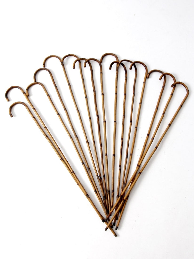Collection of 14 Antique Bamboo Canes Circa 1920: Collection of 14 Antique Bamboo Canes Circa 1920 This antique collection features fourteen bamboo canes dating back to circa 1920. Each slender walking stick is designed with metal tip ends and rounde