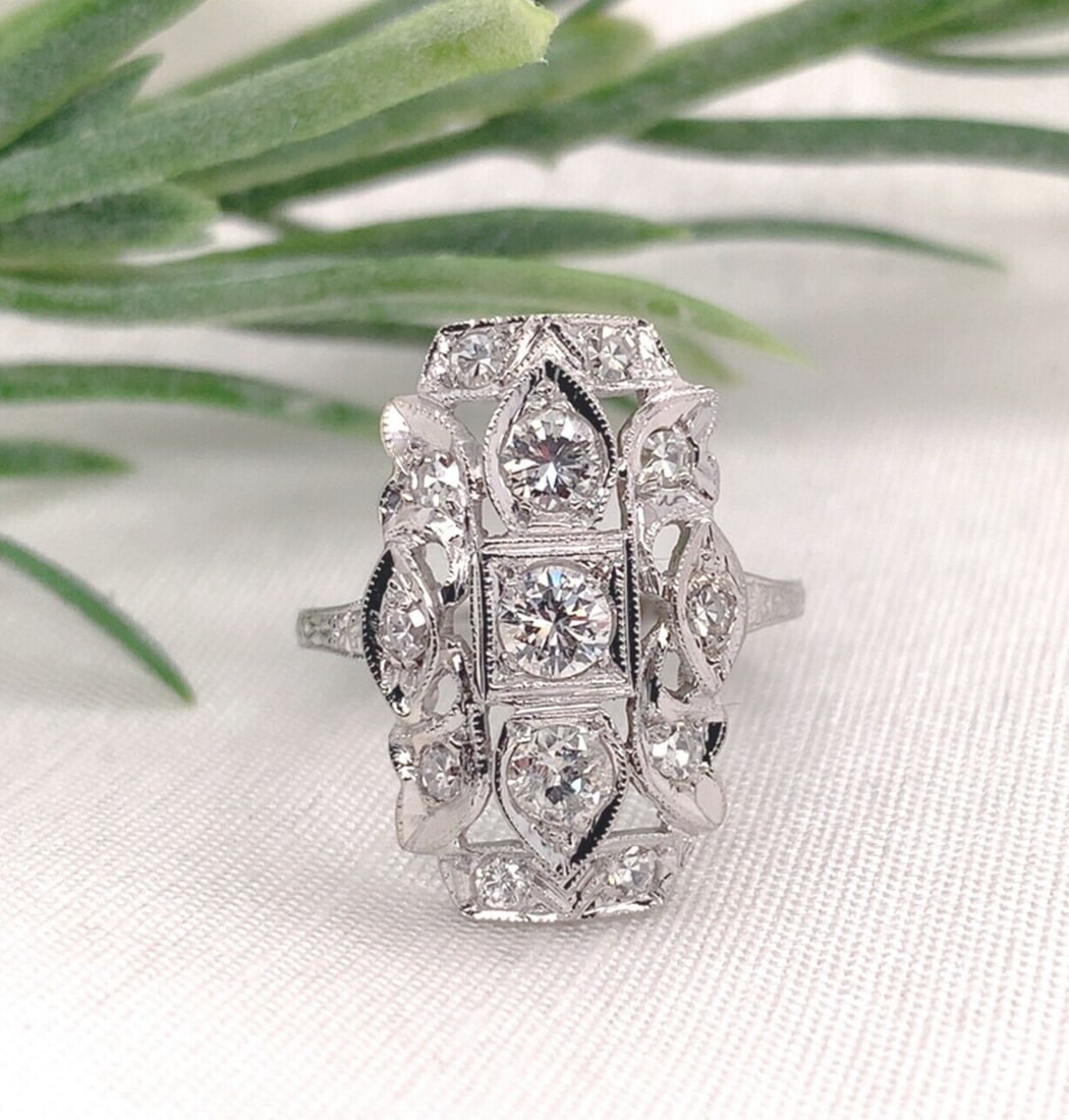 1920s 18k White Gold Filigree Ring with 0.75ct Diamond: 1920s 18k White Gold Filigree Ring with 0.75ct Diamond This exquisite 18k white gold filigree ring features a stunning arrangement of thirteen genuine natural diamonds, totaling approximately 3/4 cara