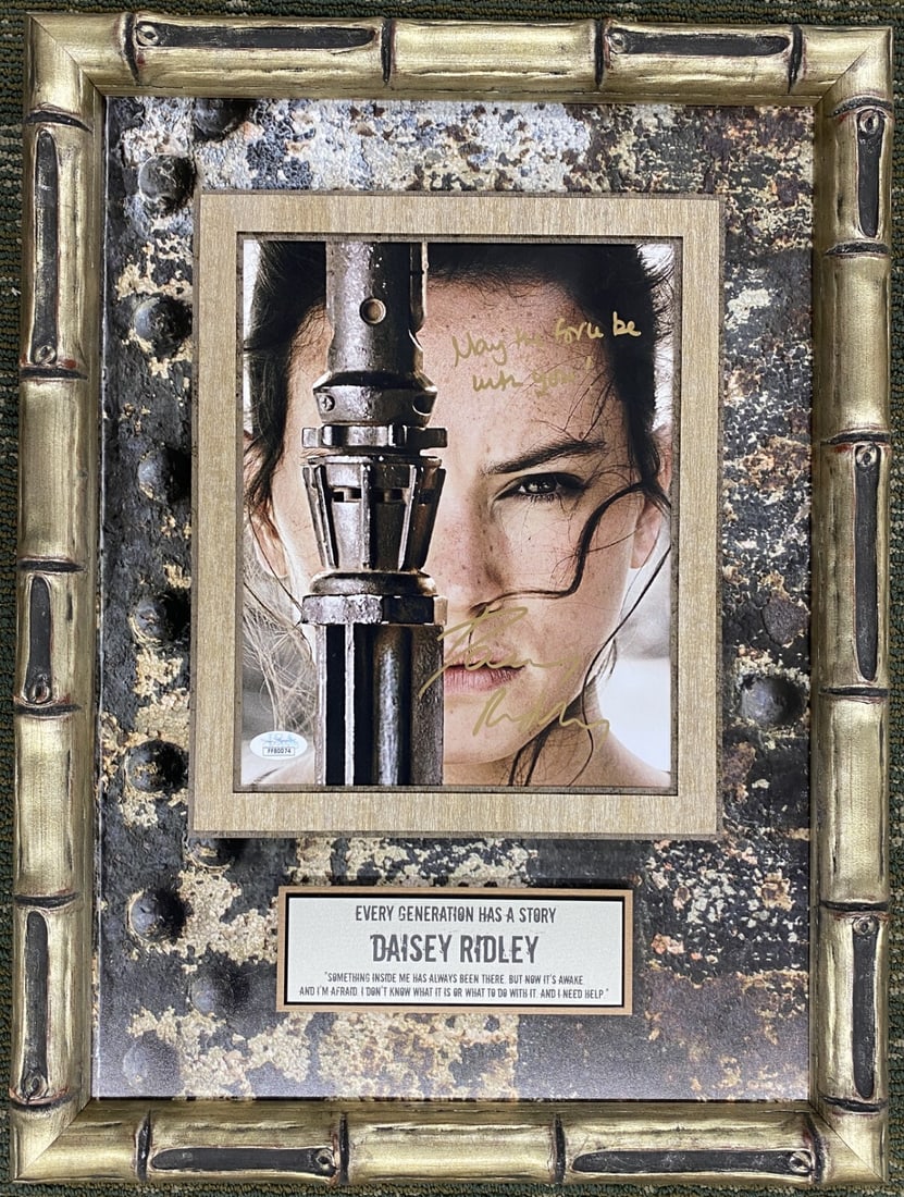 Daisy Ridley Rey Signed Photo Custom Framed JSA Star Wars: Daisy Ridley Rey Signed Photo Custom Framed JSA Star Wars This custom framed photograph features Daisy Ridley as Rey from the iconic Star Wars franchise, specifically from 'The Rise of Skywalker'. The