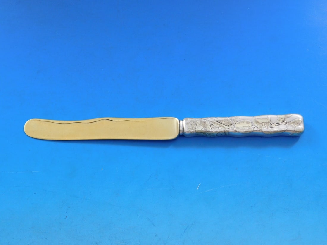 Tiffany & Co. Lap Over Edge Sterling Silver Dessert Knife with Apple Motif: Tiffany & Co. Lap Over Edge Sterling Silver Dessert Knife with Apple Motif This exquisite dessert knife from Tiffany & Co. showcases the elegant Lap Over Edge pattern, characterized by its acid-etched