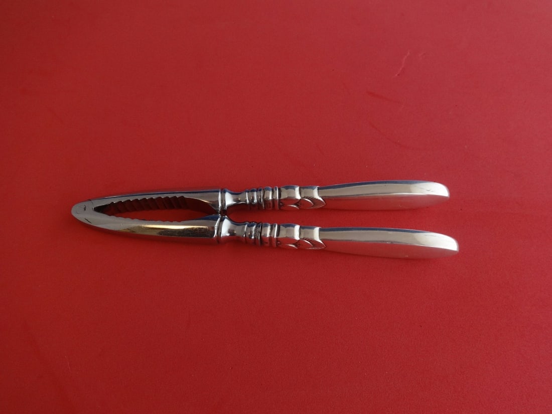 Georg Jensen Cactus Sterling Silver Nut Cracker 6 1/8": Georg Jensen Cactus Sterling Silver Nut Cracker 6 1/8" This exquisite nut cracker, crafted by Georg Jensen, features a stunning Cactus pattern. Made from high-quality sterling silver, it showcases a h