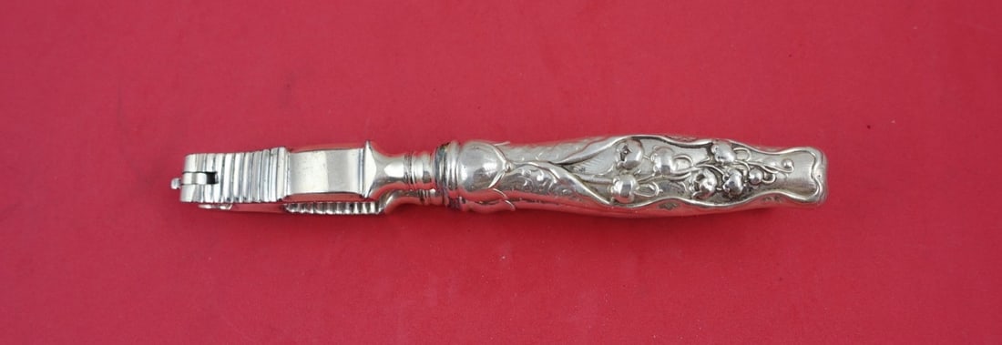 Whiting Lily of the Valley Sterling Silver Nut Cracker 6 3/4": Whiting Lily of the Valley Sterling Silver Nut Cracker 6 3/4" This exquisite nut cracker from the renowned Whiting brand is part of the elegant Lily of the Valley pattern, patented in 1885. Crafted fr